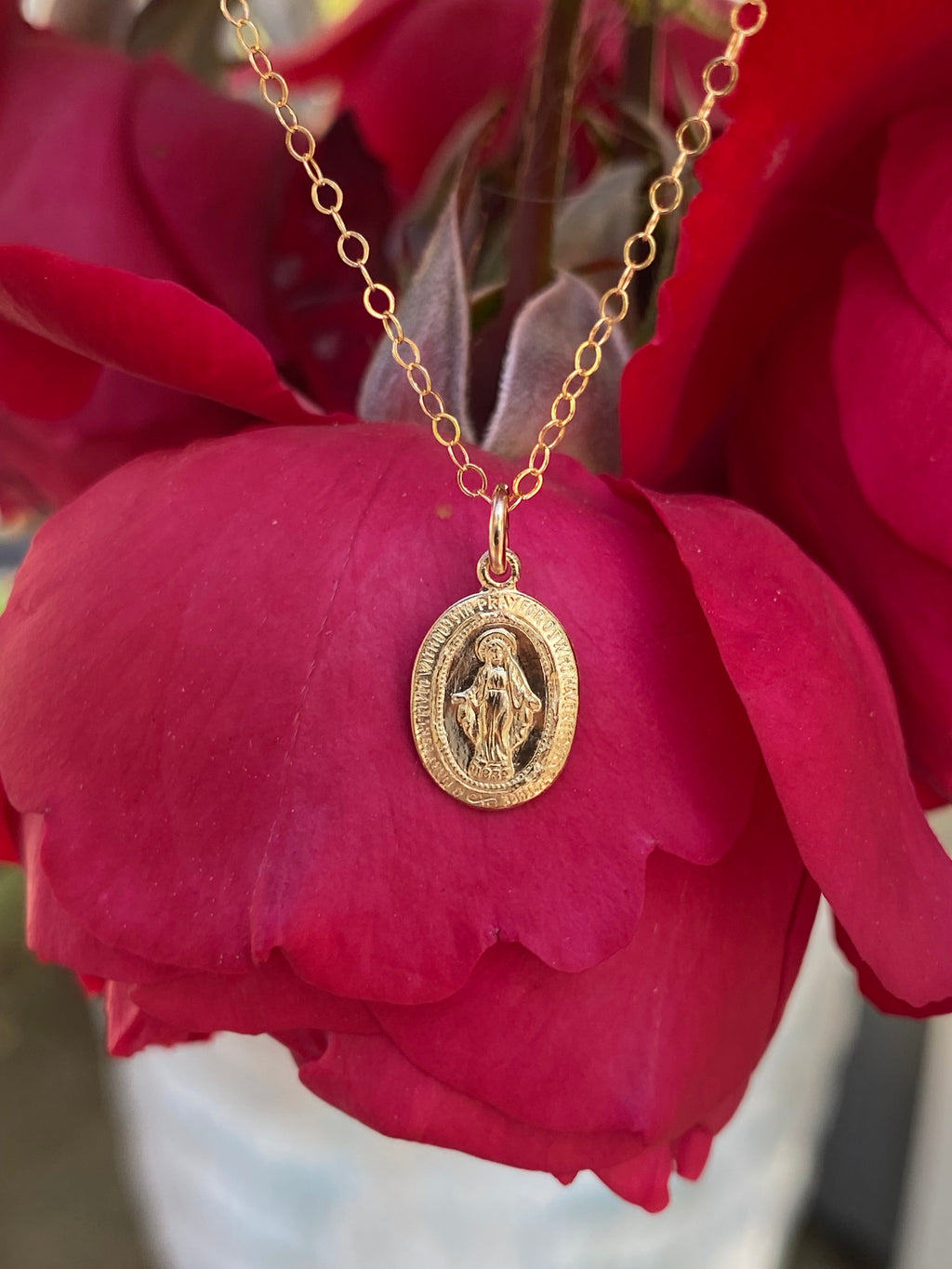 Gold-tone chain necklace with large oval religious medal pendant