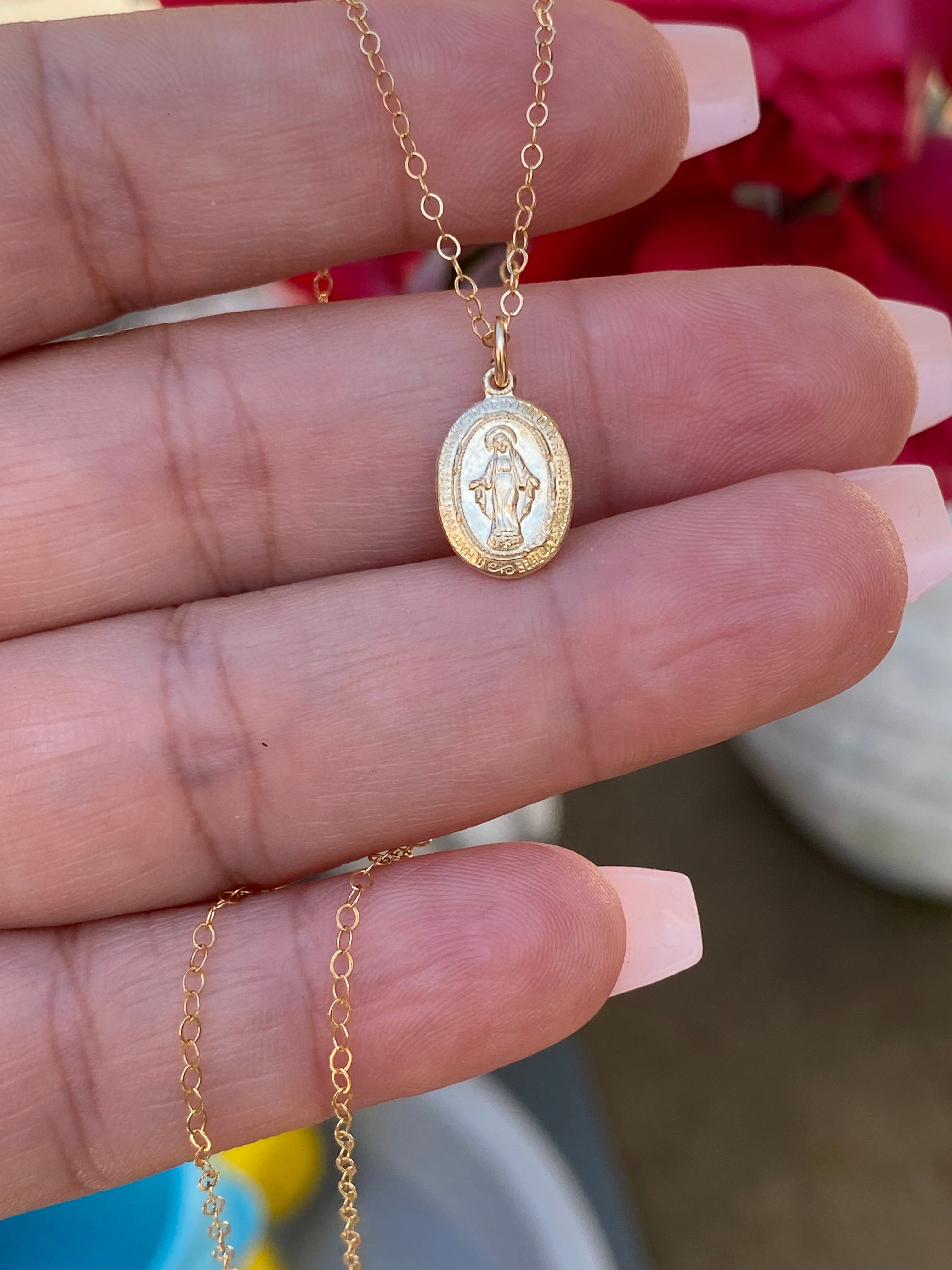 Gold-tone chain necklace with oval Miraculous Medal pendant featuring Mary figure