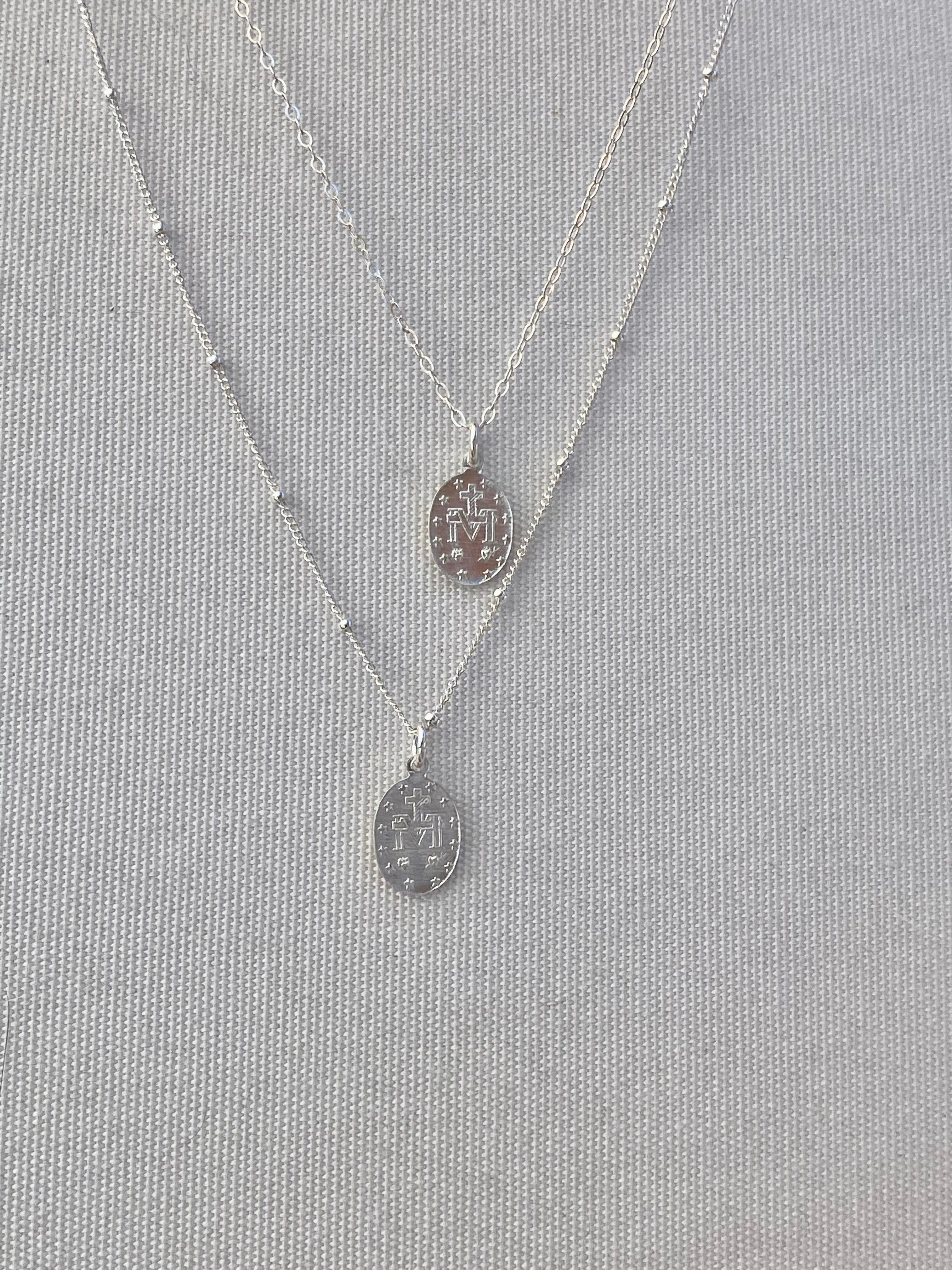 Silver miraculous medal necklaces with oval pendant and thin chain links