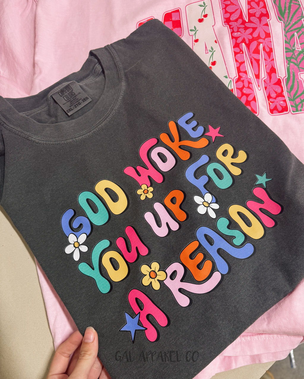 Dark gray T-shirt with colorful 'God woke you up for a reason' chest graphic
