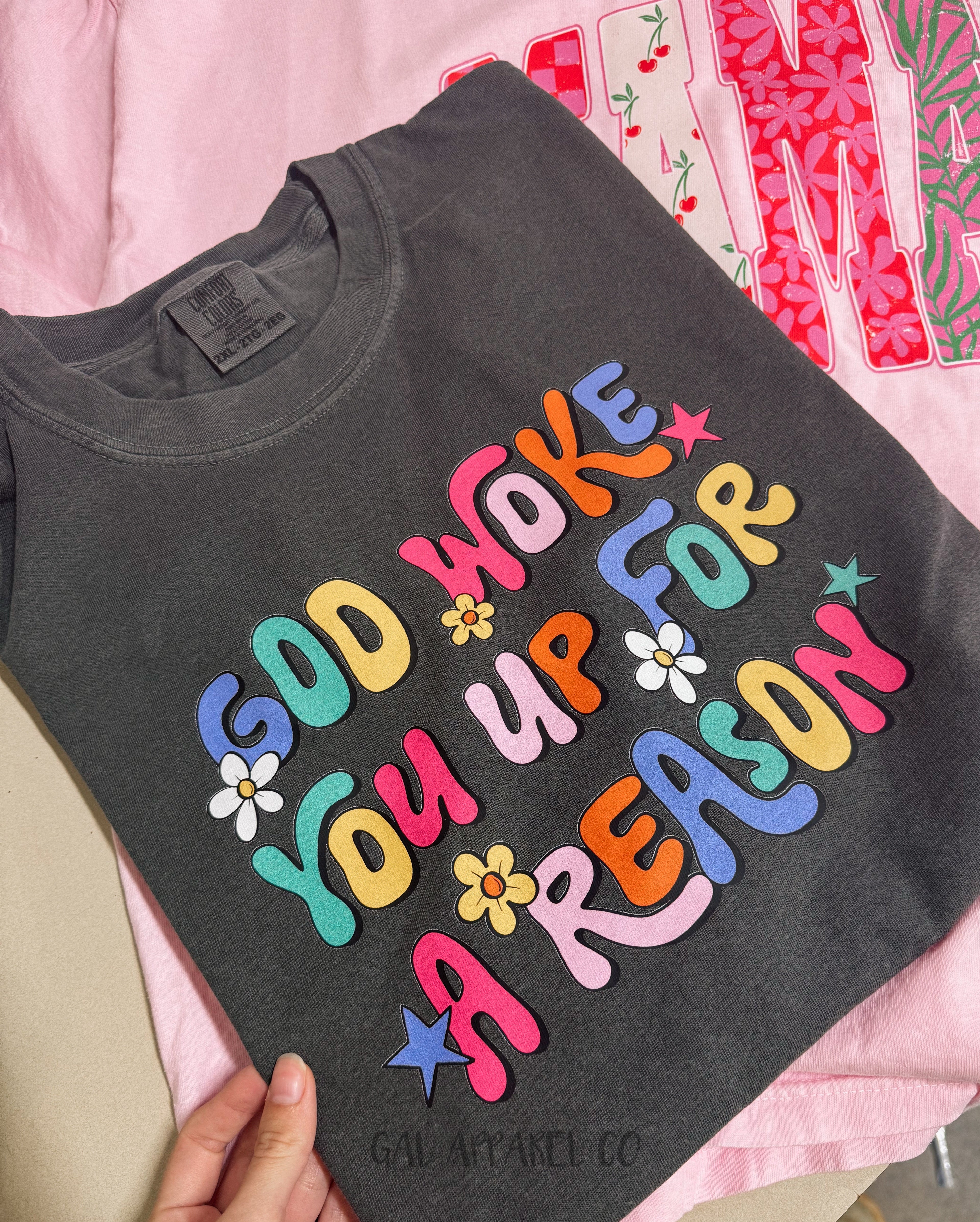 Dark gray T-shirt with colorful 'God woke you up for a reason' chest graphic