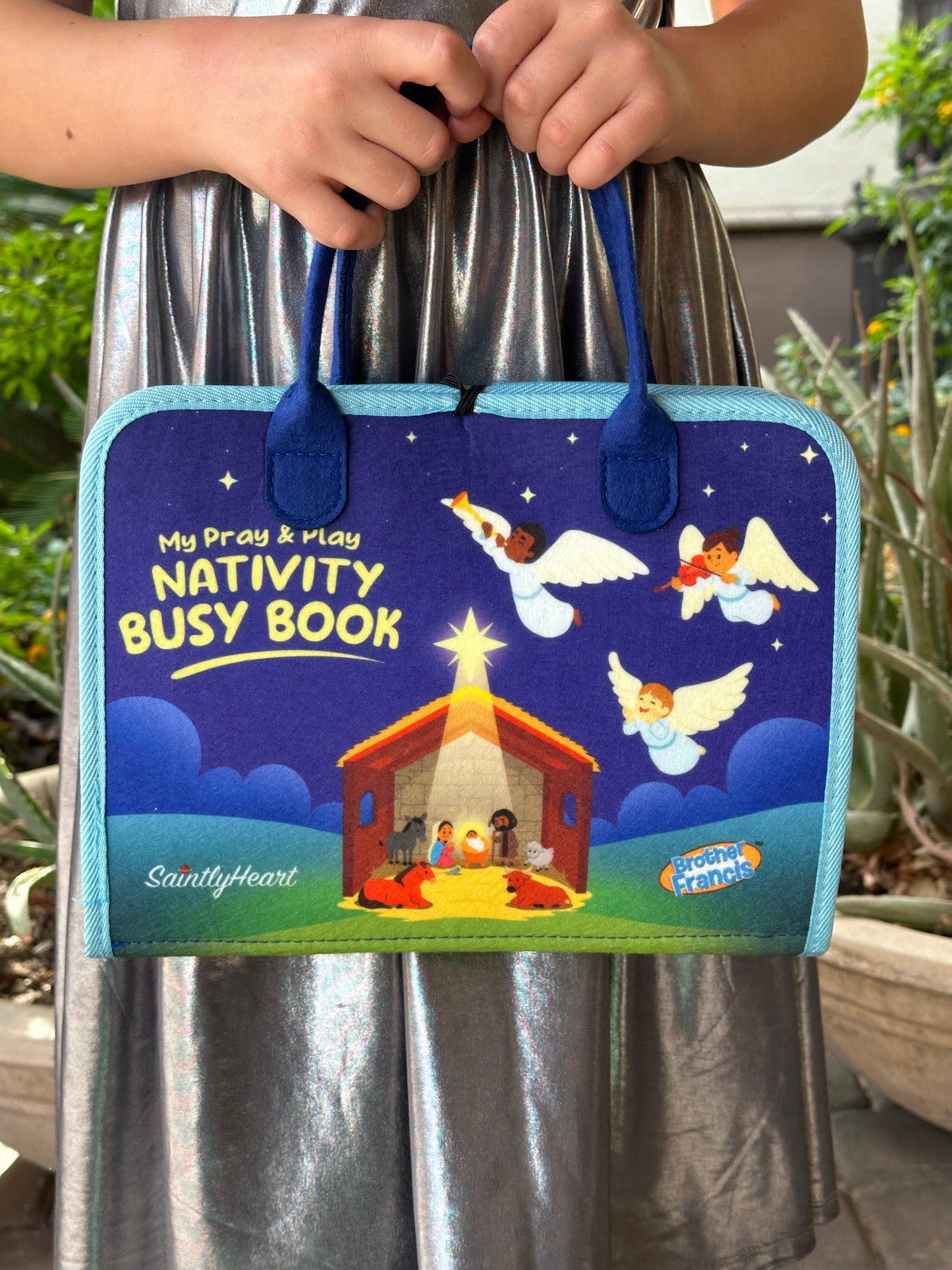 Children’s nativity busy book with blue cover and stitched handle pockets