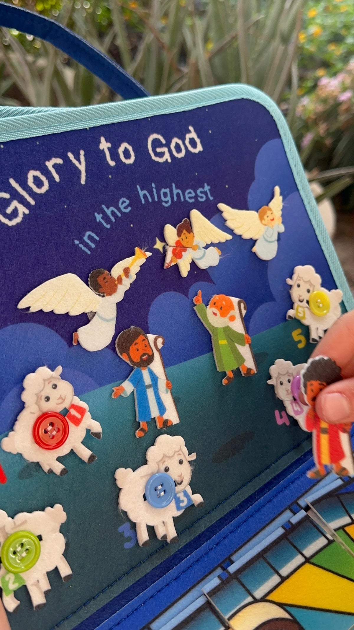 Blue nativity busy book page with scripture text and felt nativity characters