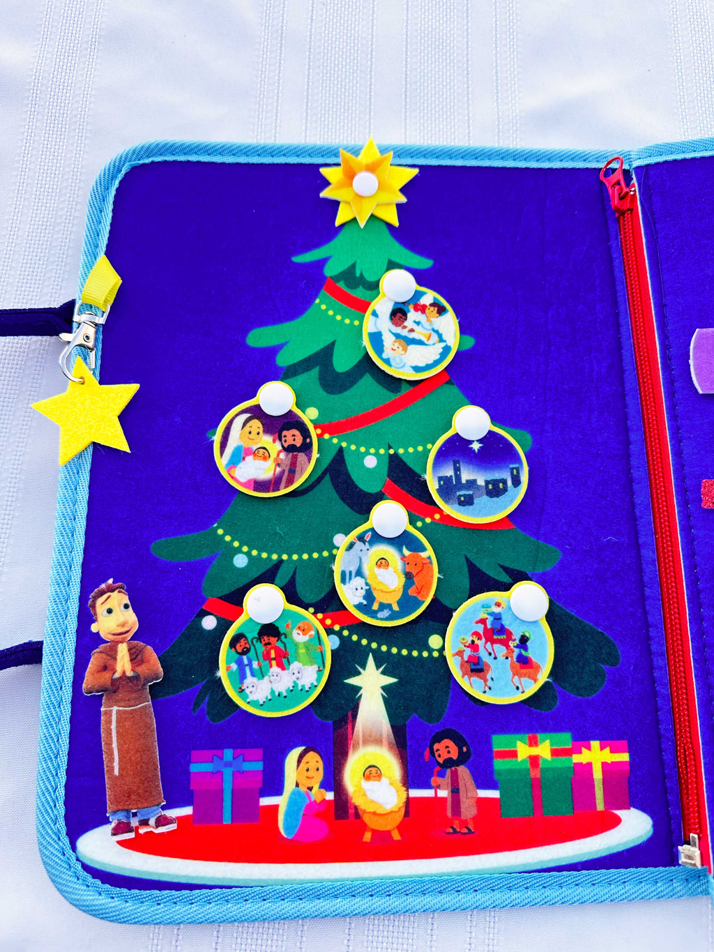 Nativity busy book open tree page with felt ornaments, circles, and nativity figures