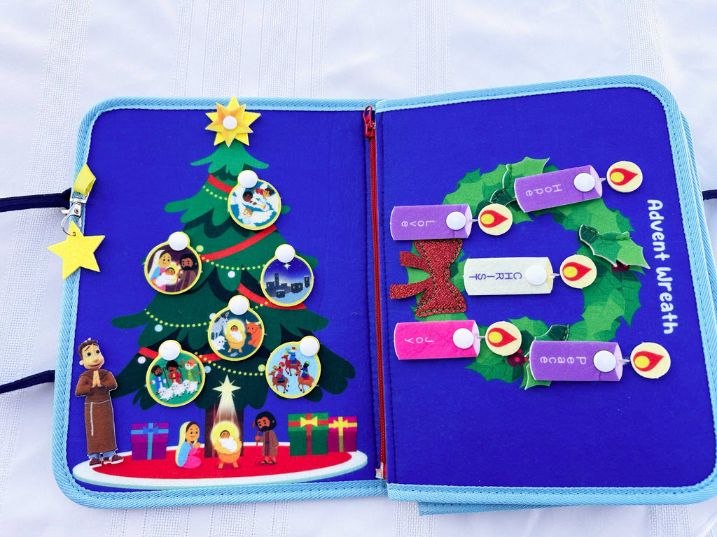Nativity busy book open spread with Christmas tree scene and slide-card activity