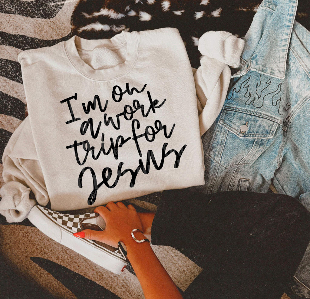 Light cream crew-neck tee with black script “I’m on a work trip for Jesus” print