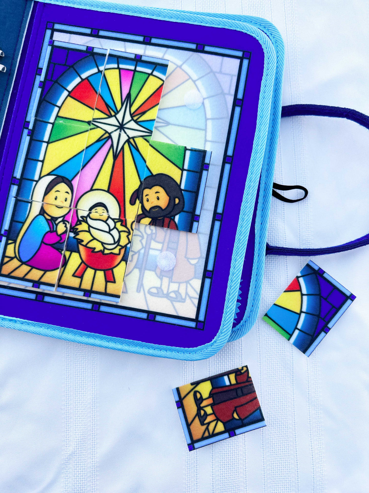 Nativity busy book open page with stained-glass scene and hanging play flap
