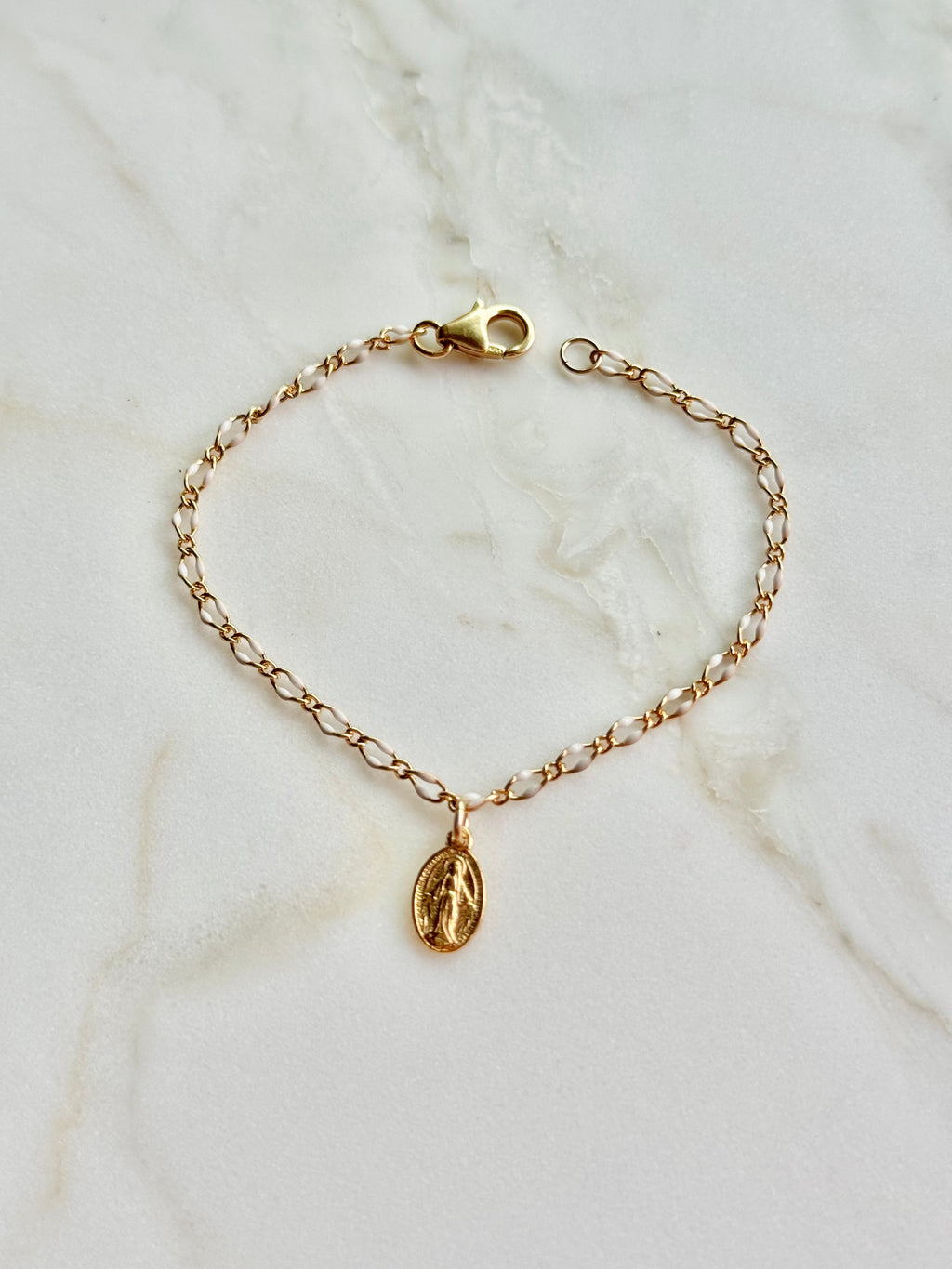 Gold chain bracelet with oval Miraculous Medal charm and toggle clasp