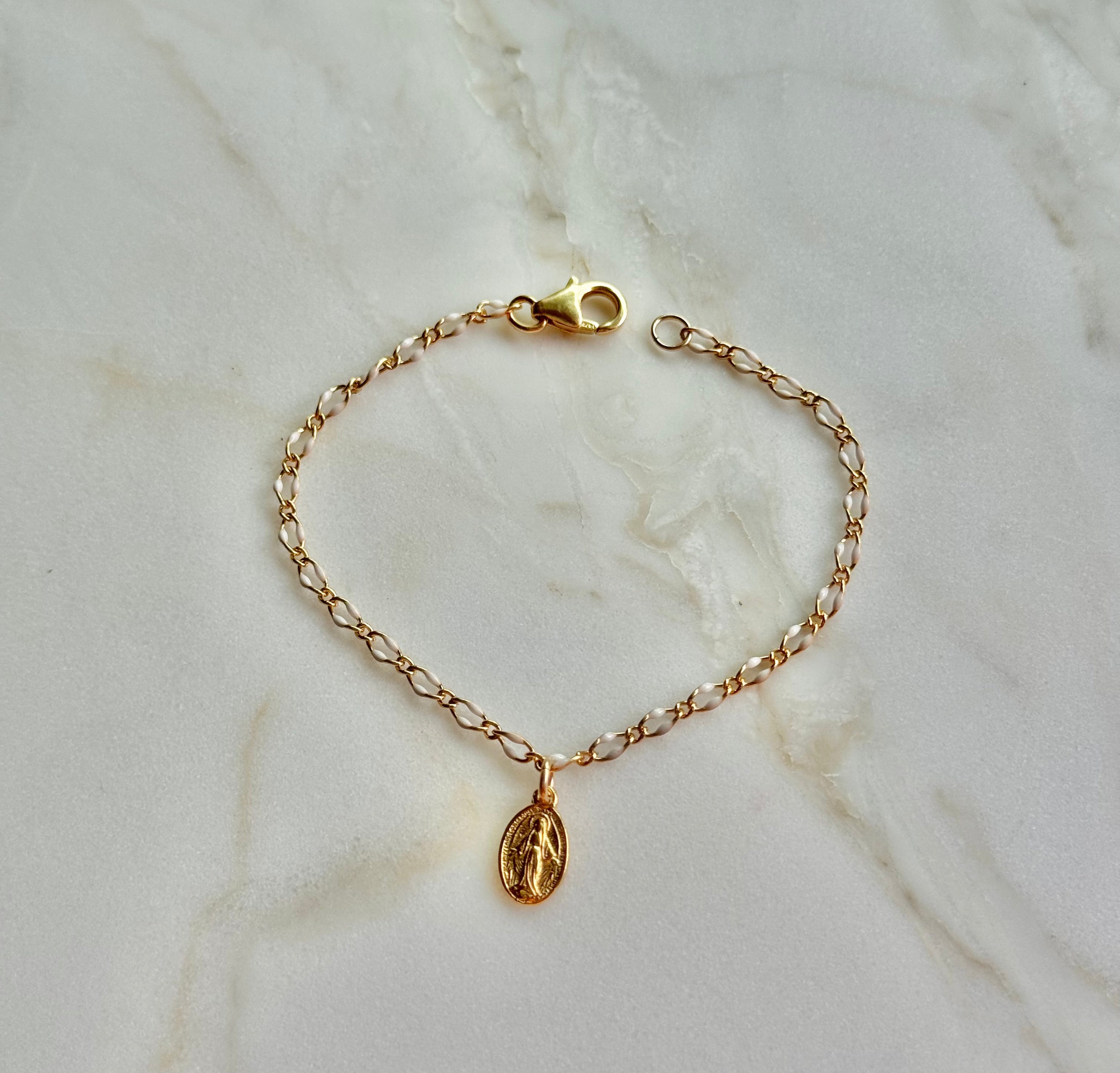 Gold chain bracelet with oval Miraculous Medal charm and toggle clasp