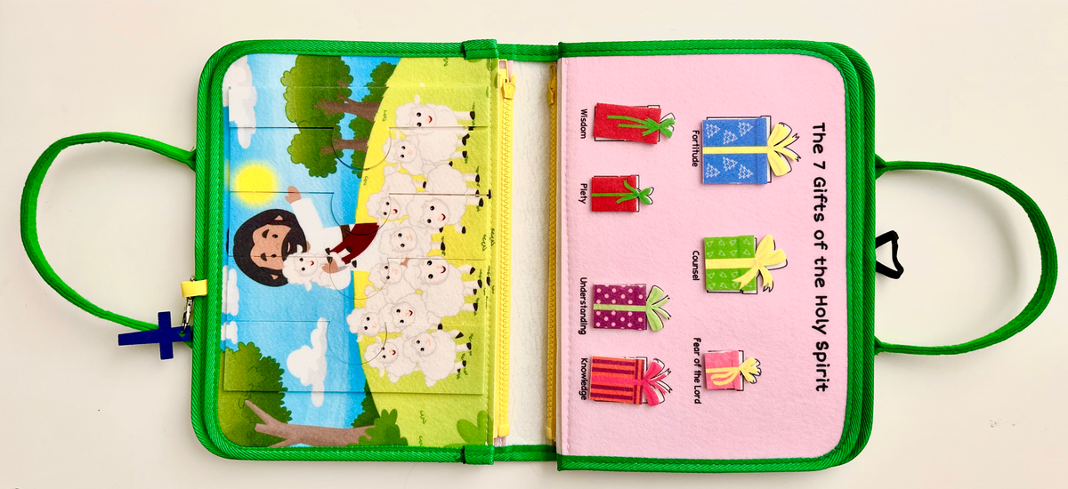 Open felt busy book with illustrated scene on the left and story/action icons on the right