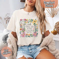 Ivory Comfort Colors crewneck tee with floral cross graphic and scripture text front