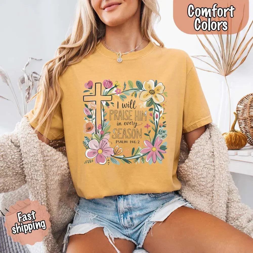 Mustard gold crewneck tee with floral cross and flowers, “I will praise Him in every season”
