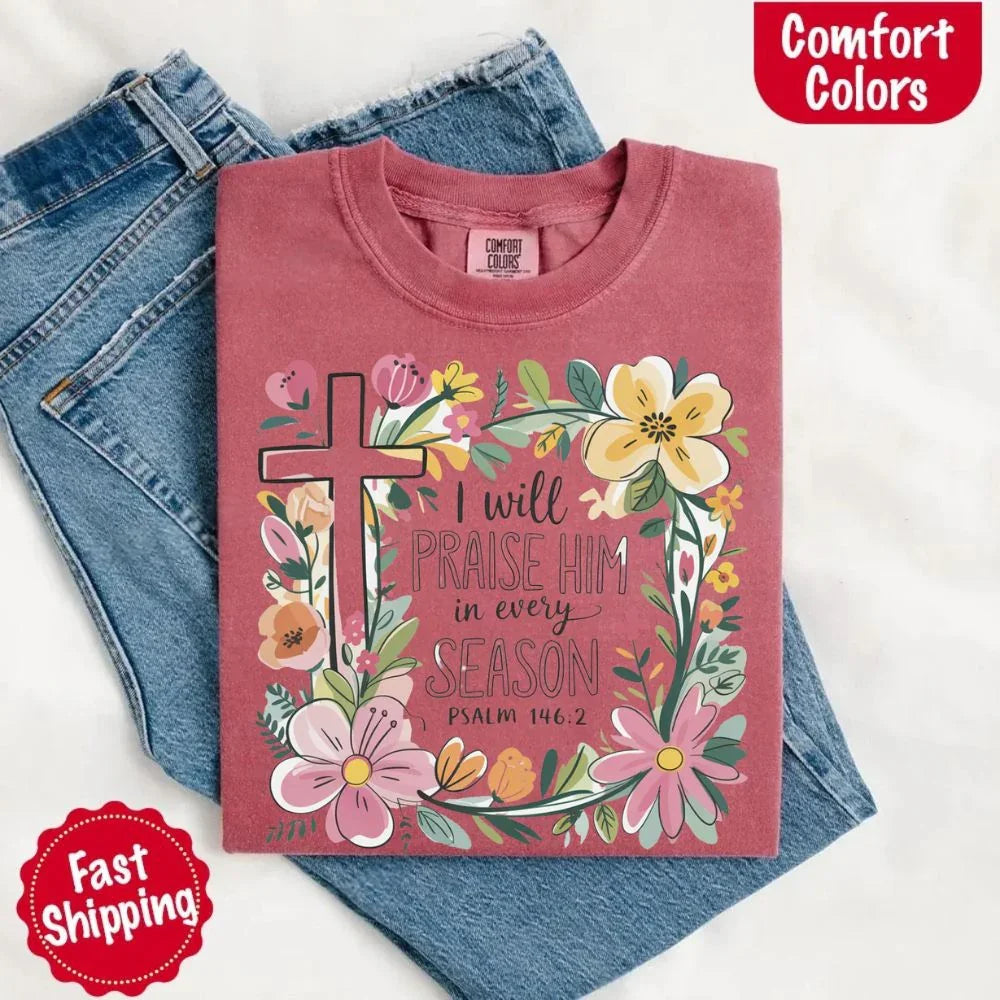 Rose pink crewneck tee with floral cross and flowers, “I will praise Him in every season”