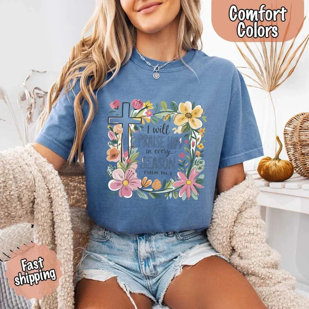 Blue comfort tee with floral cross frame and “I will praise him in every season” print