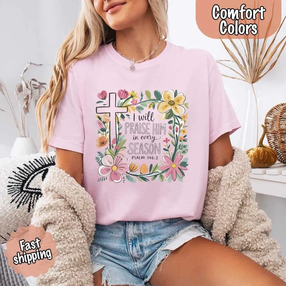 Light pink Comfort Colors crewneck tee with floral cross and scripture text graphic