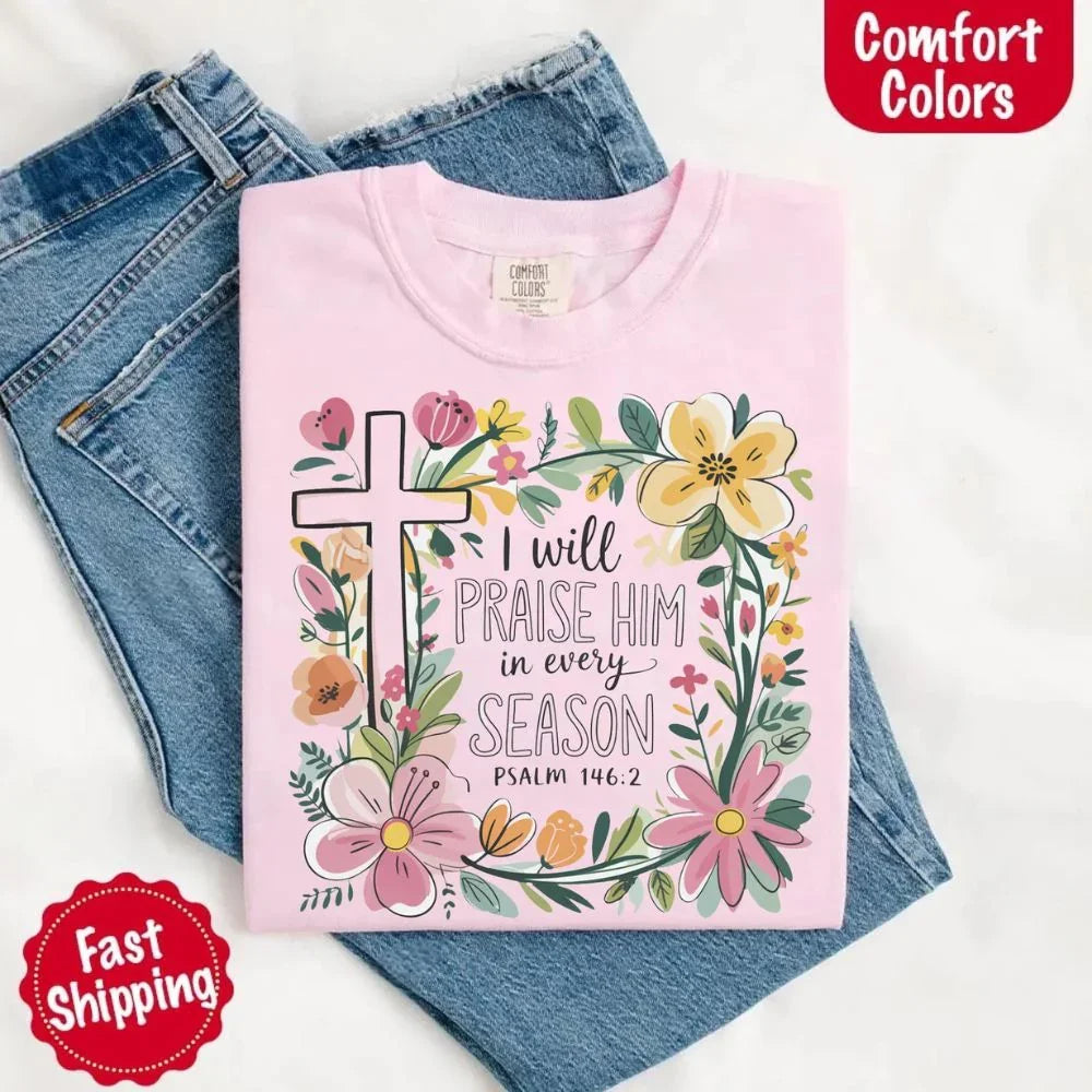 Light pink Comfort Colors crewneck tee with floral cross and scripture text graphic