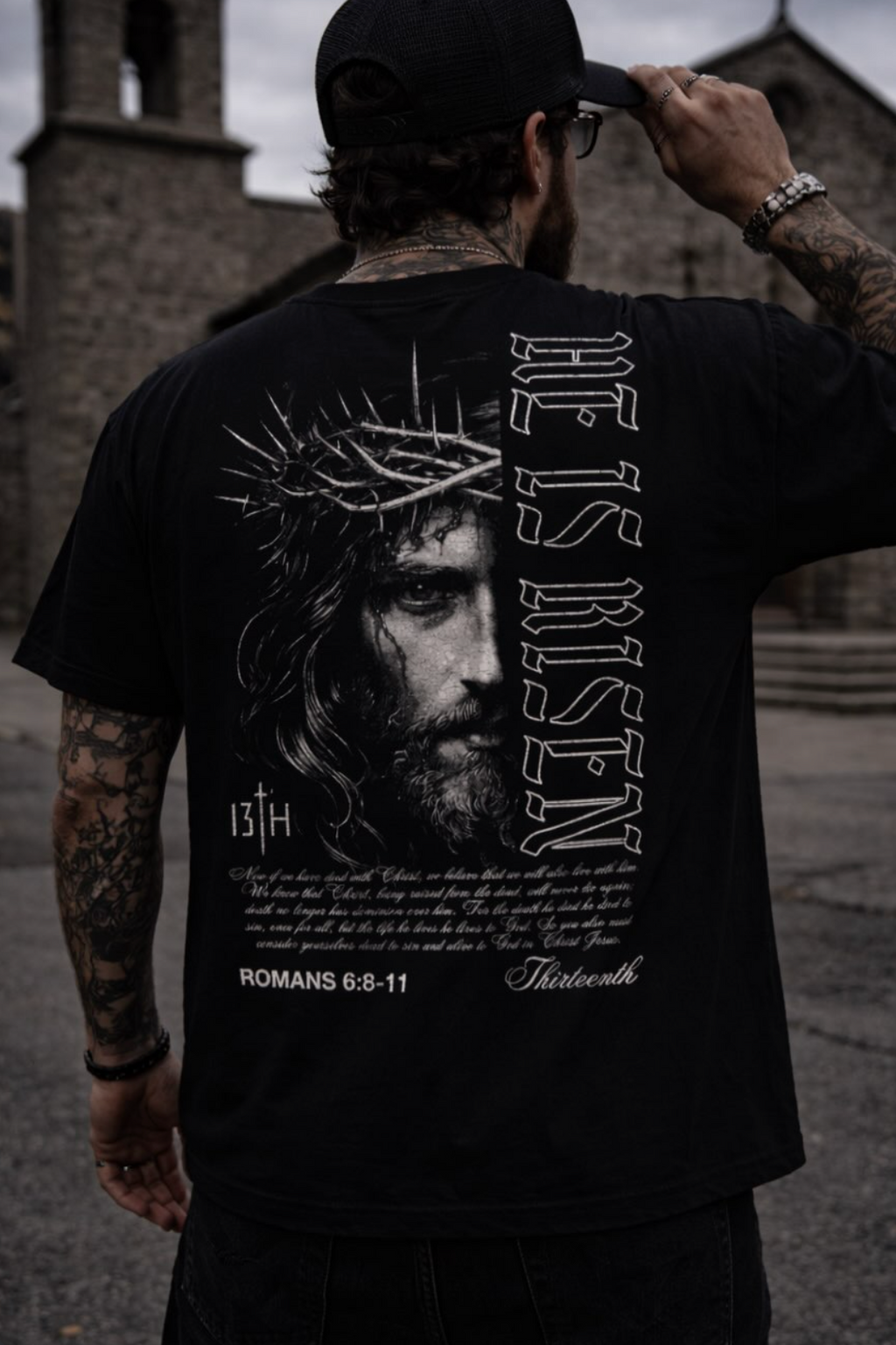 Black graphic t-shirt back view with portrait, “13th,” and Roman text