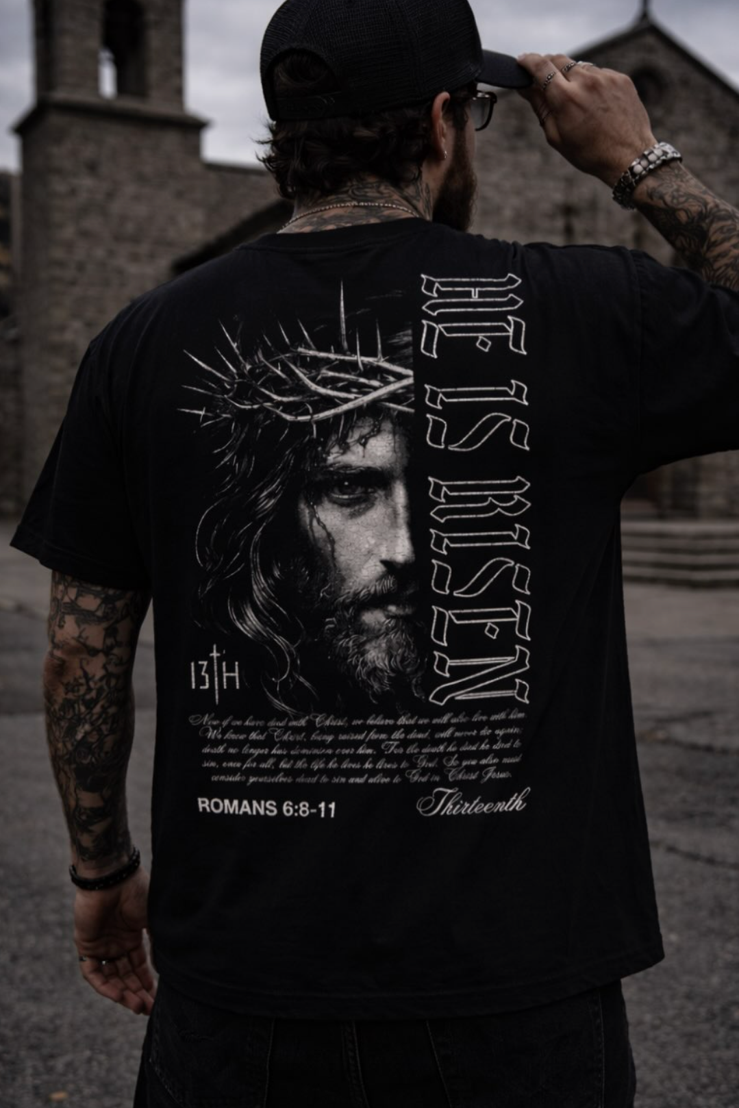 Black graphic t-shirt back view with portrait, “13th,” and Roman text