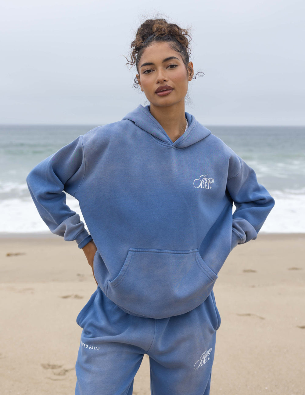 Blue unisex hoodie with front kangaroo pocket and chest Imago DEI logo