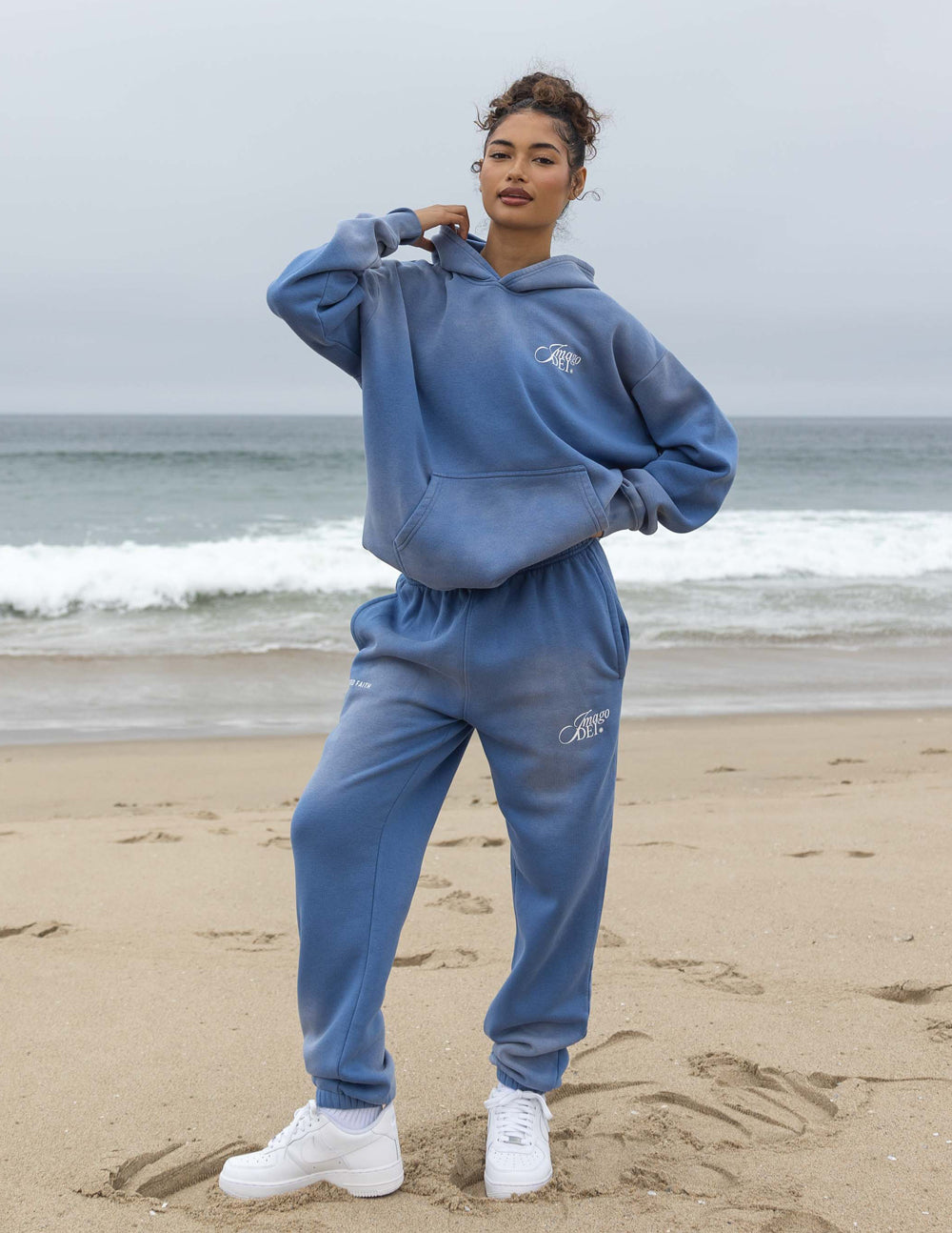 Blue unisex hoodie with hood, kangaroo pocket, and Imago DEI logo