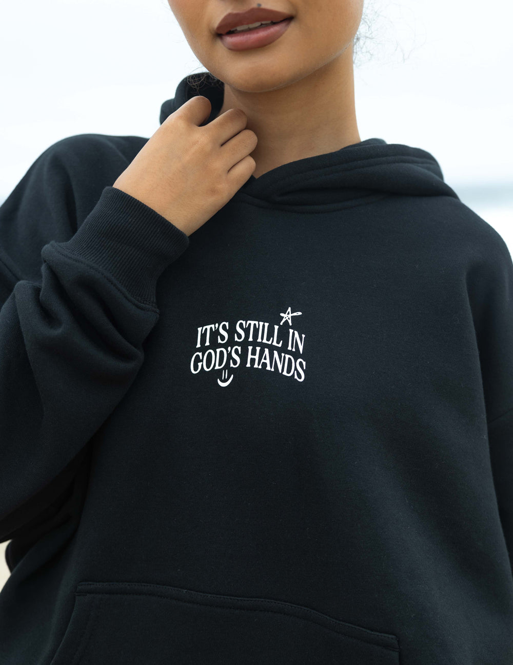 Black unisex hoodie with small chest graphic and front pocket