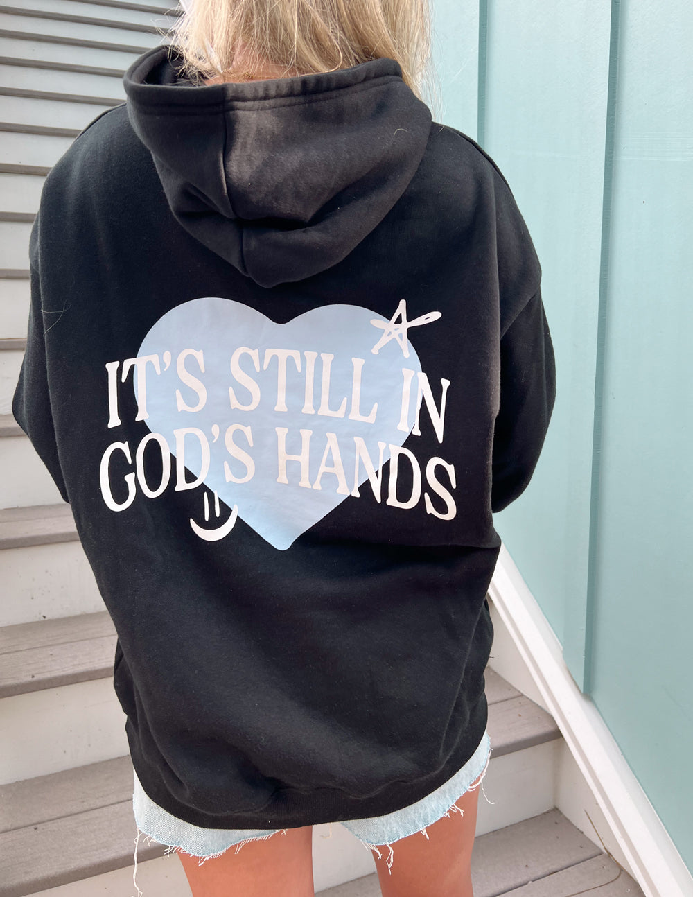 Black unisex hoodie with heart logo and text on the back