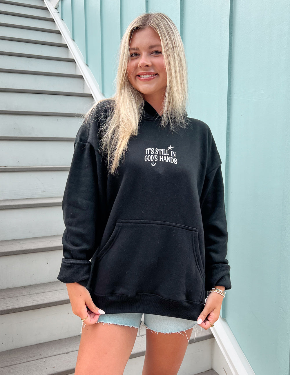 Black unisex hoodie with hood and small chest graphic, front view
