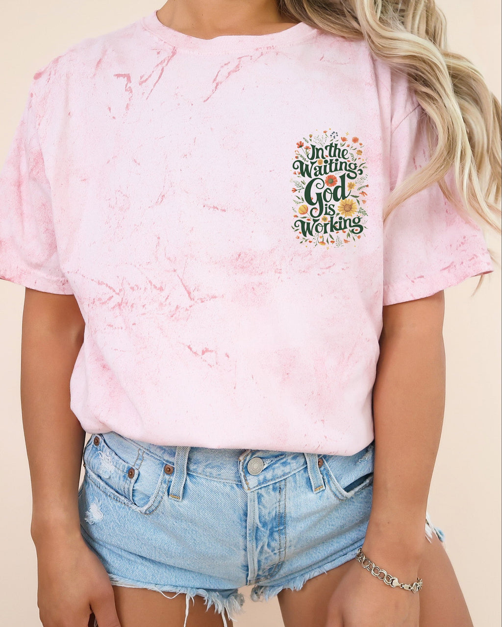 Pink women’s graphic T-shirt with short sleeves and chest logo print