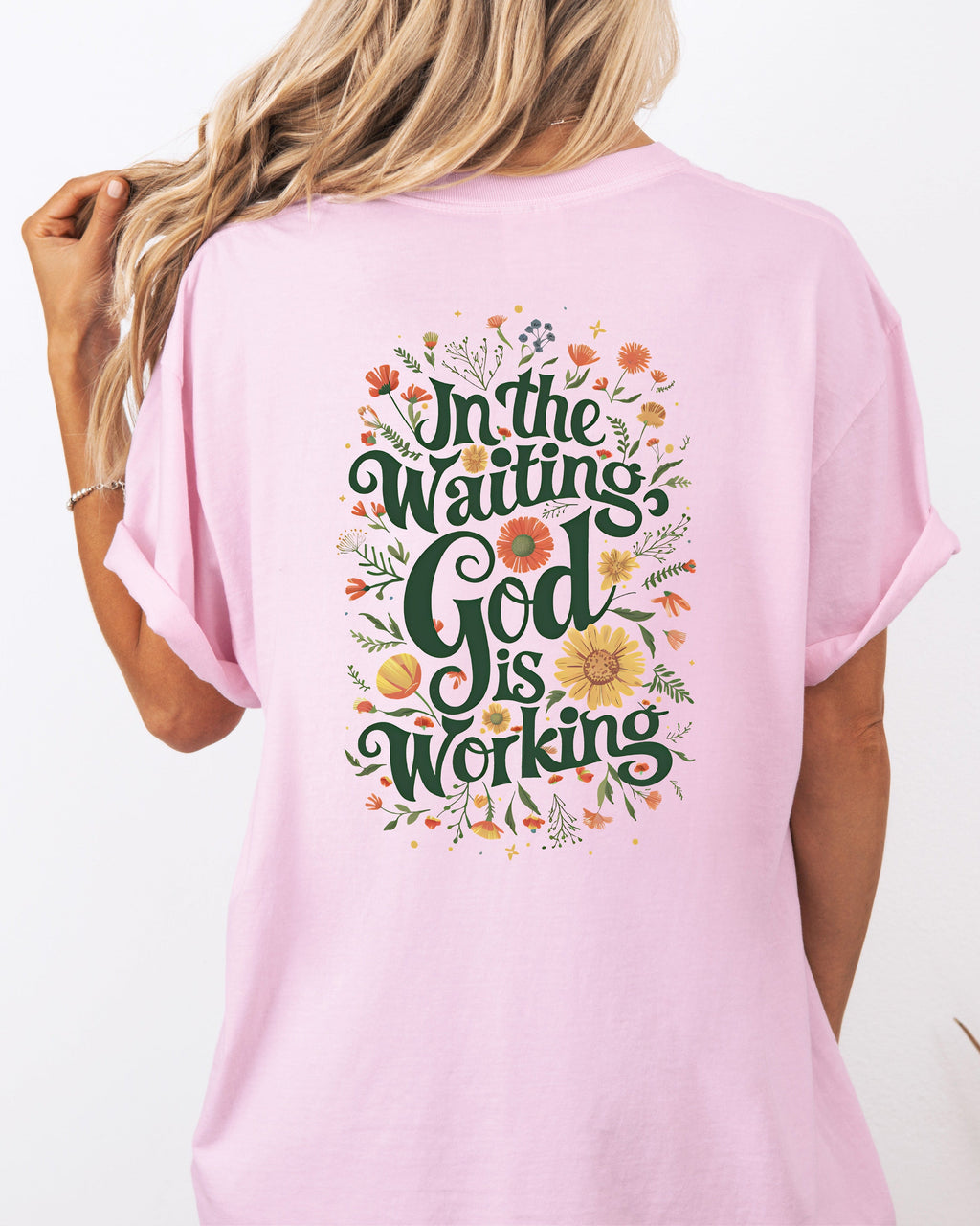 Orchid pink T-shirt with floral 'In The Waiting God Is Working' graphic on back