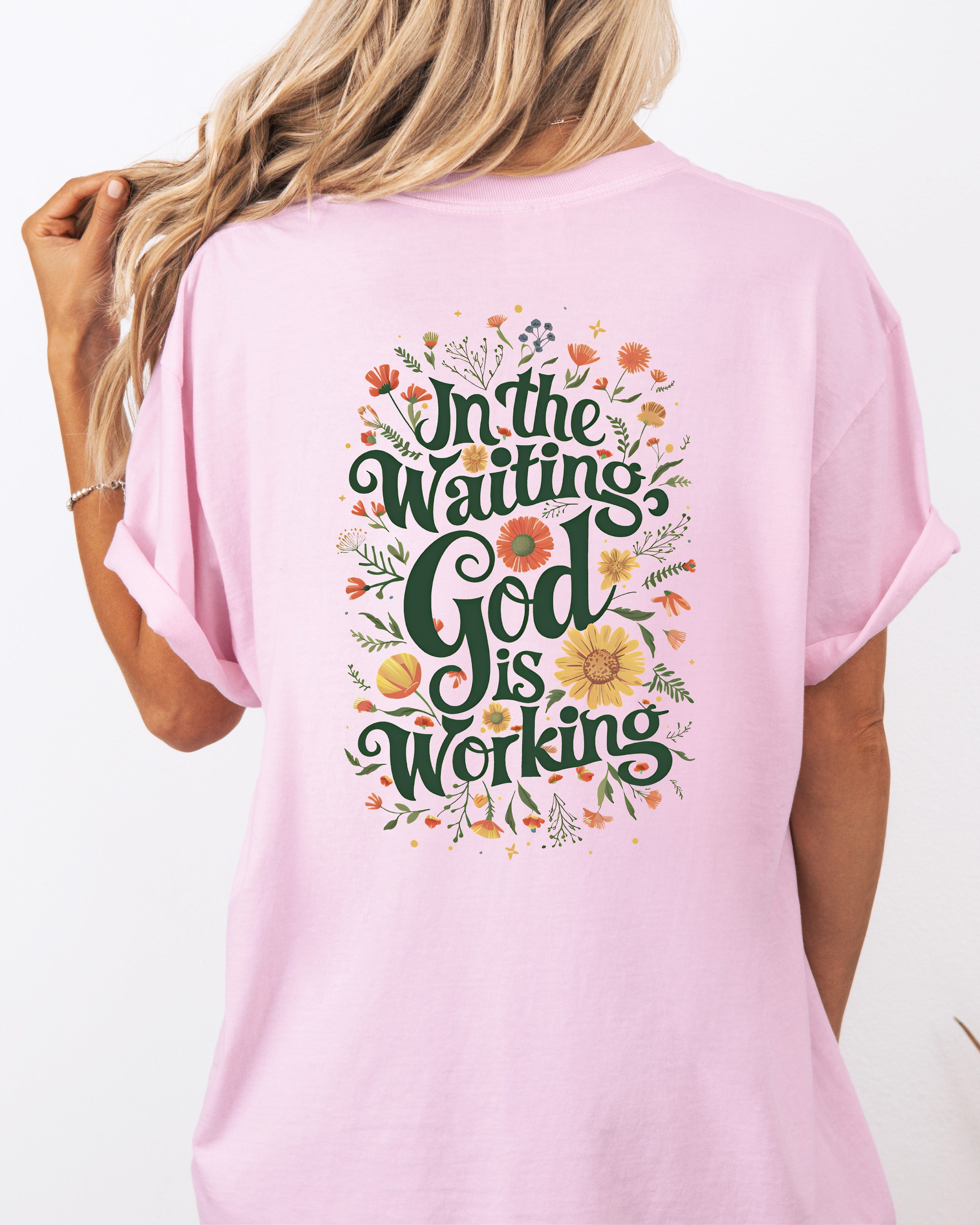 Orchid pink T-shirt with floral 'In The Waiting God Is Working' graphic on back