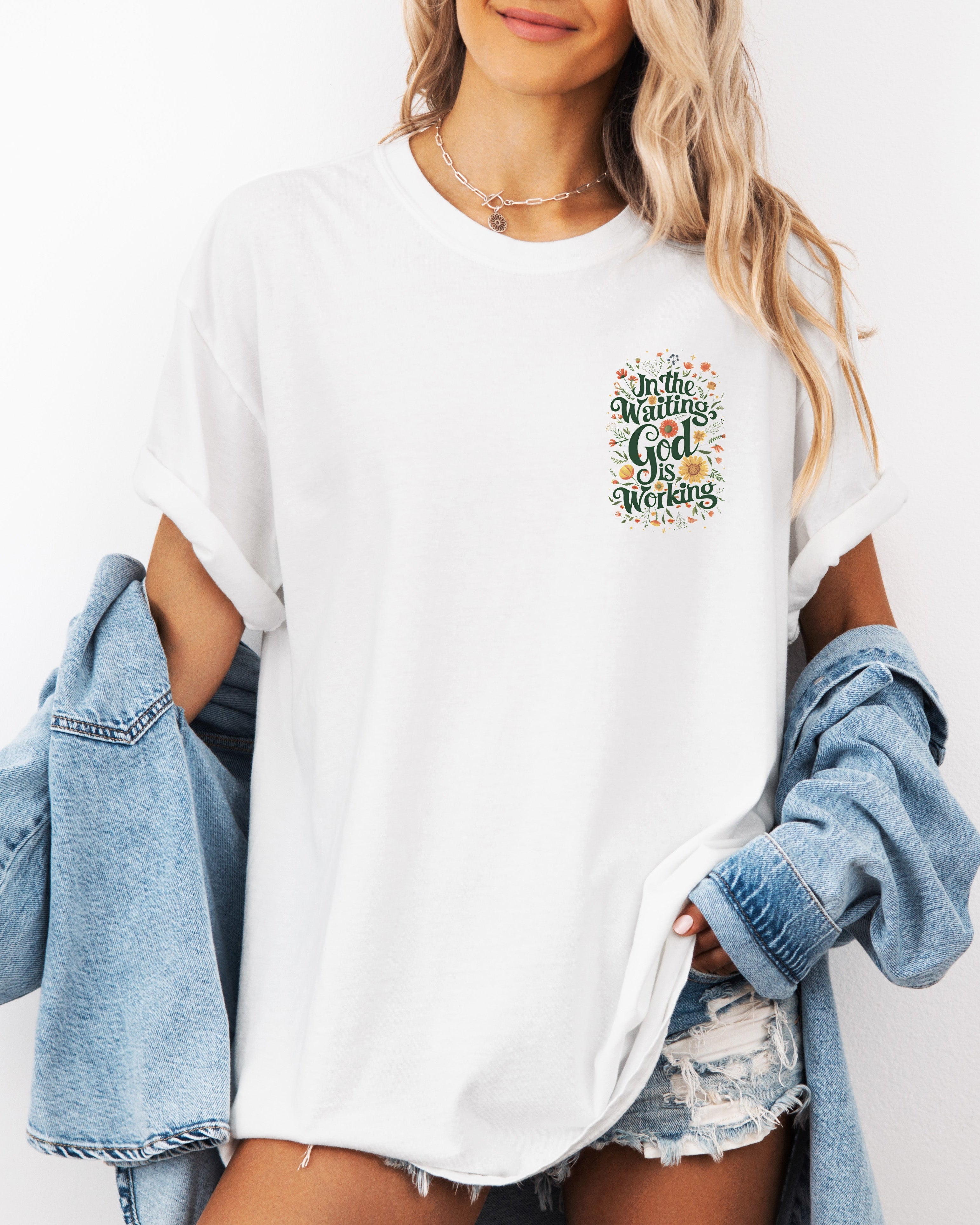 White unisex T-shirt with 'In The Waiting God Is Working' graphic on left chest
