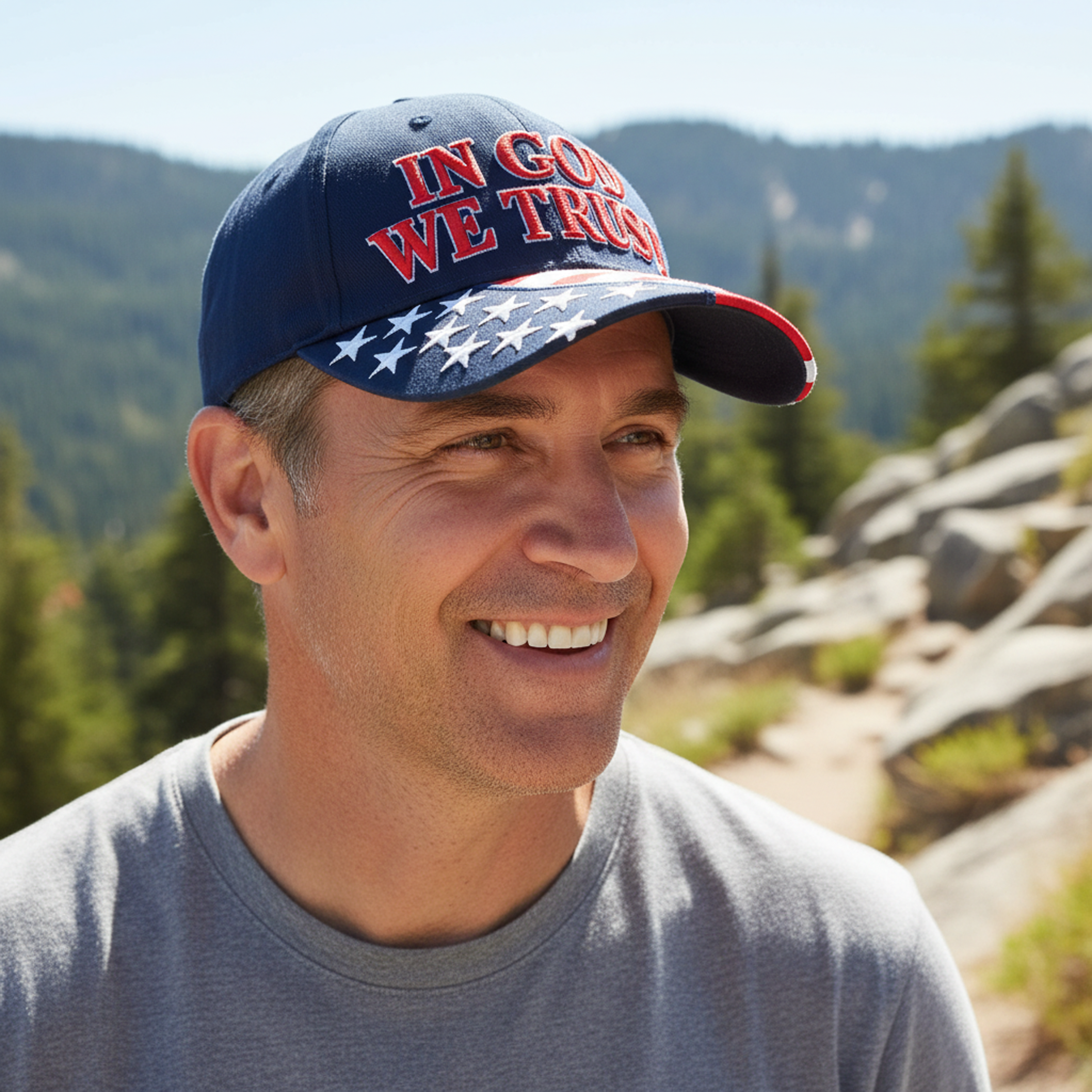 Navy baseball cap with "IN GOD WE TRUST" front text and American flag brim panel