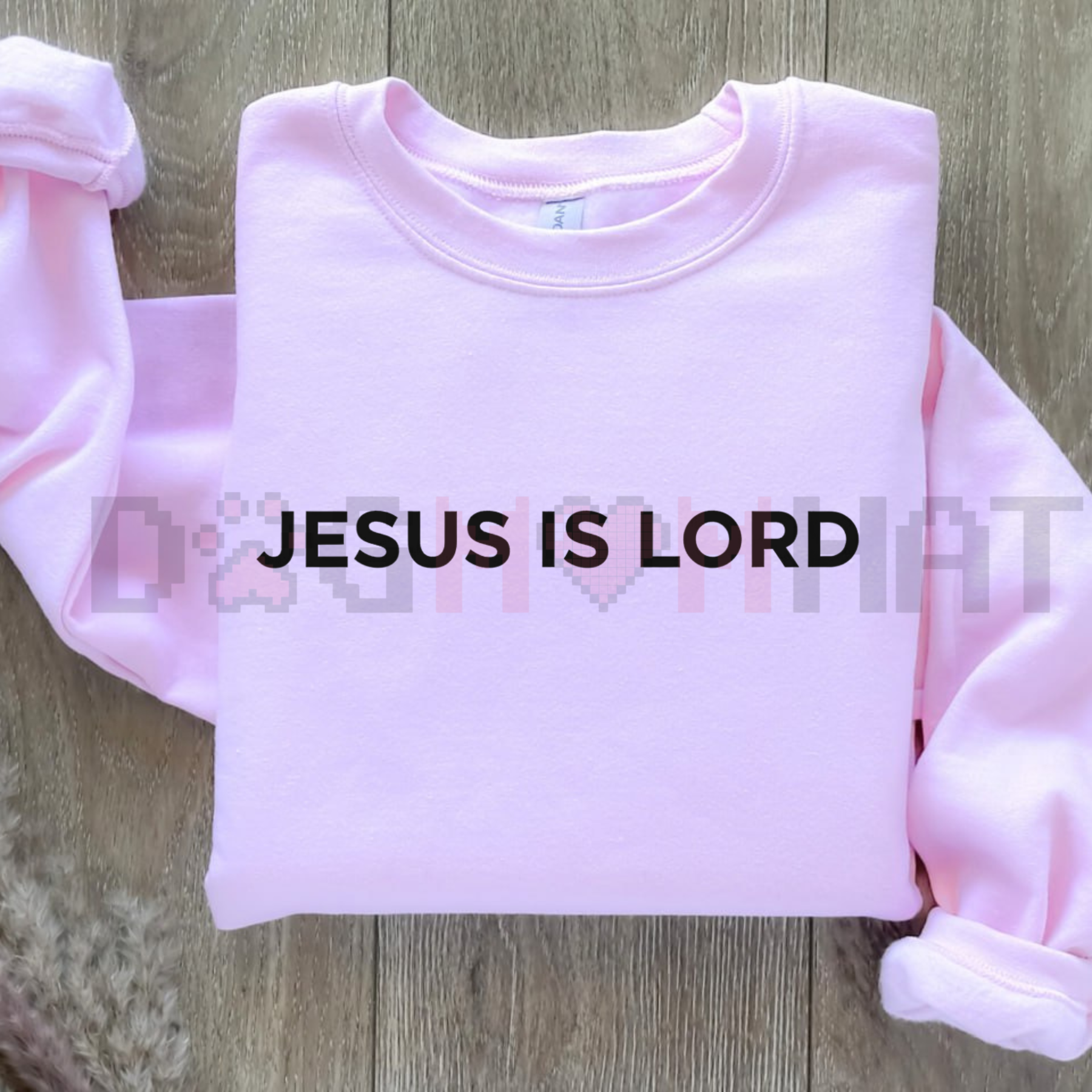 Light pink sweatshirt with bold 'JESUS IS LORD' print, crew neck and long sleeves