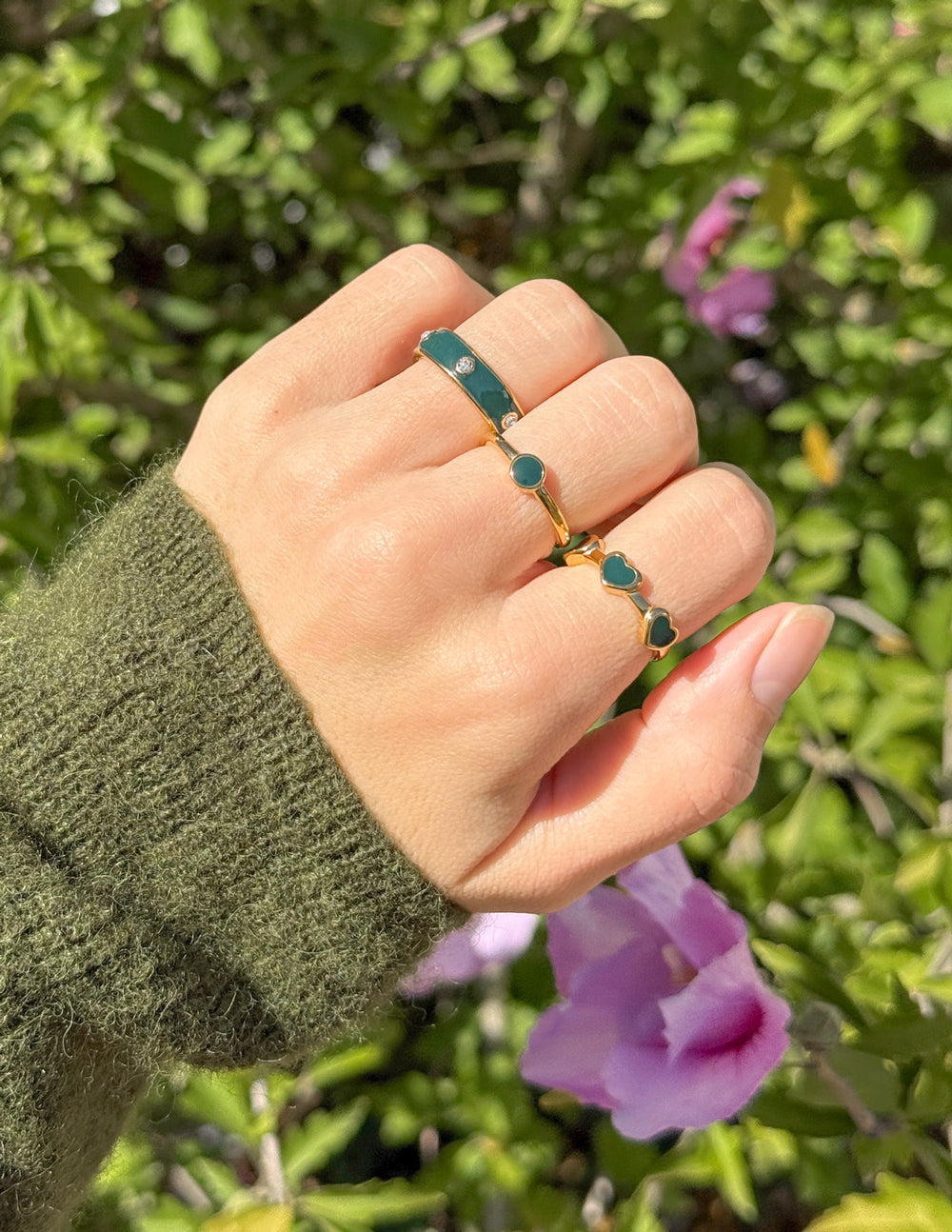 Gold-tone adjustable rings with teal-green round stones and slim band