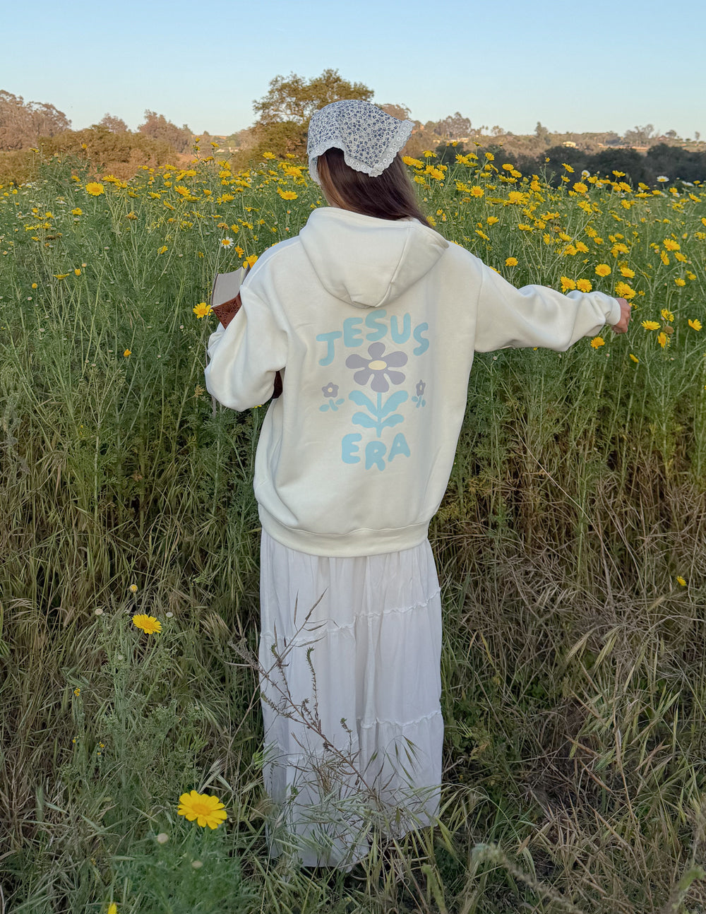 Cream unisex hoodie with blue back graphic, pullover hood, and kangaroo pocket