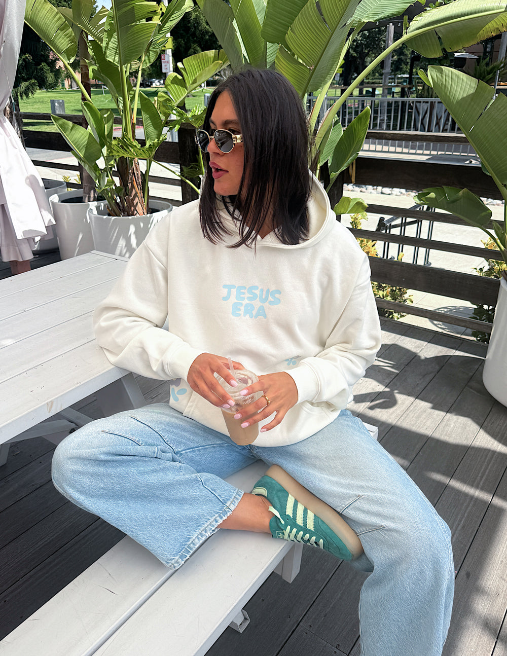 Off-white unisex hoodie with 'JESUS ERA' logo, hood down, long sleeves