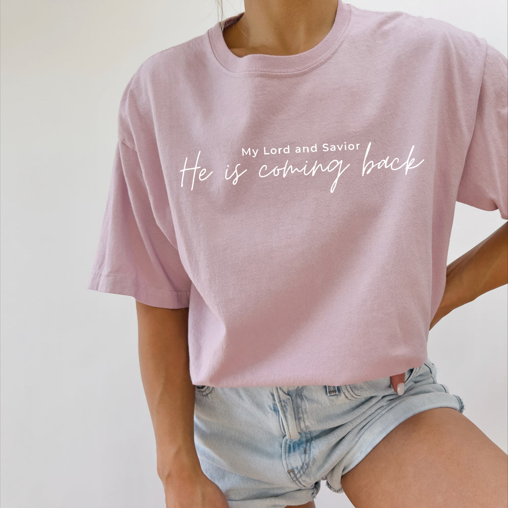 Light purple T-shirt with white 'He is coming back' script on the front