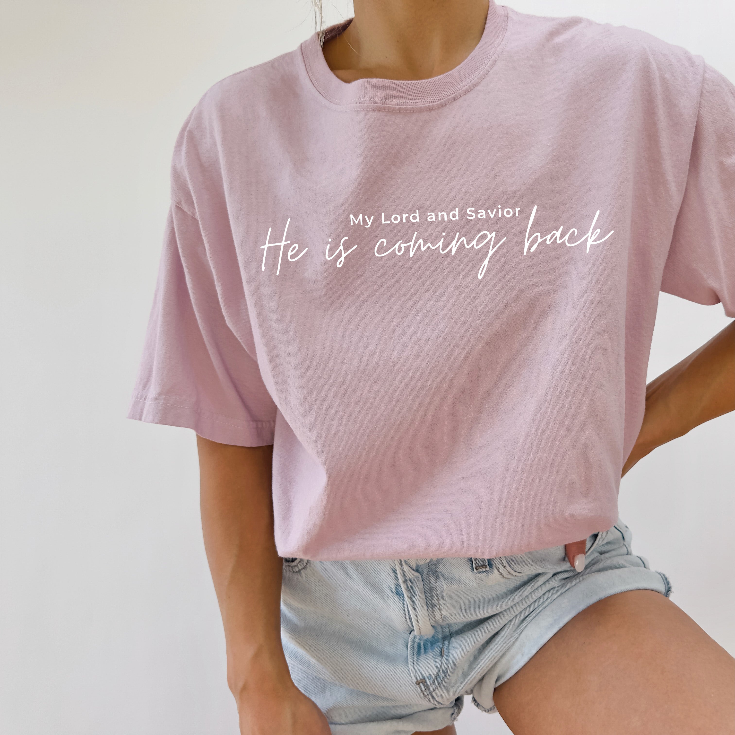 Light purple T-shirt with white 'He is coming back' script on the front