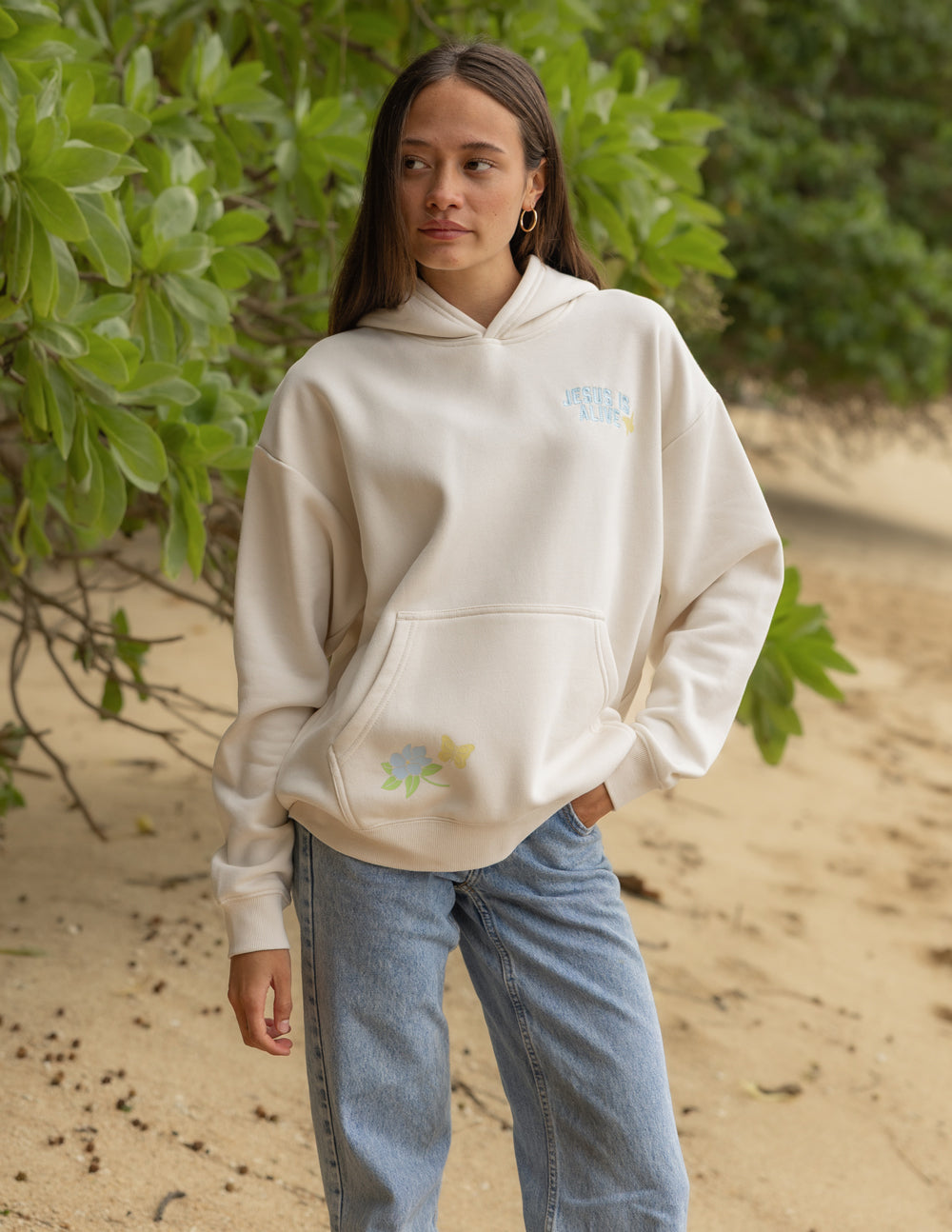 Unisex hoodie, cream, front pocket hoodie with small “JESUS IS ALIVE” graphic