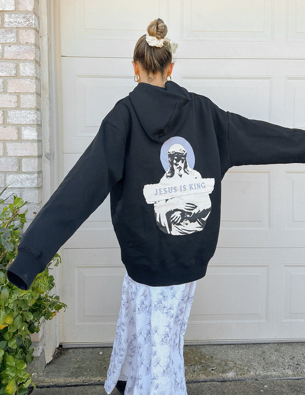 Black unisex pullover hoodie with large back portrait graphic and front kangaroo pocket