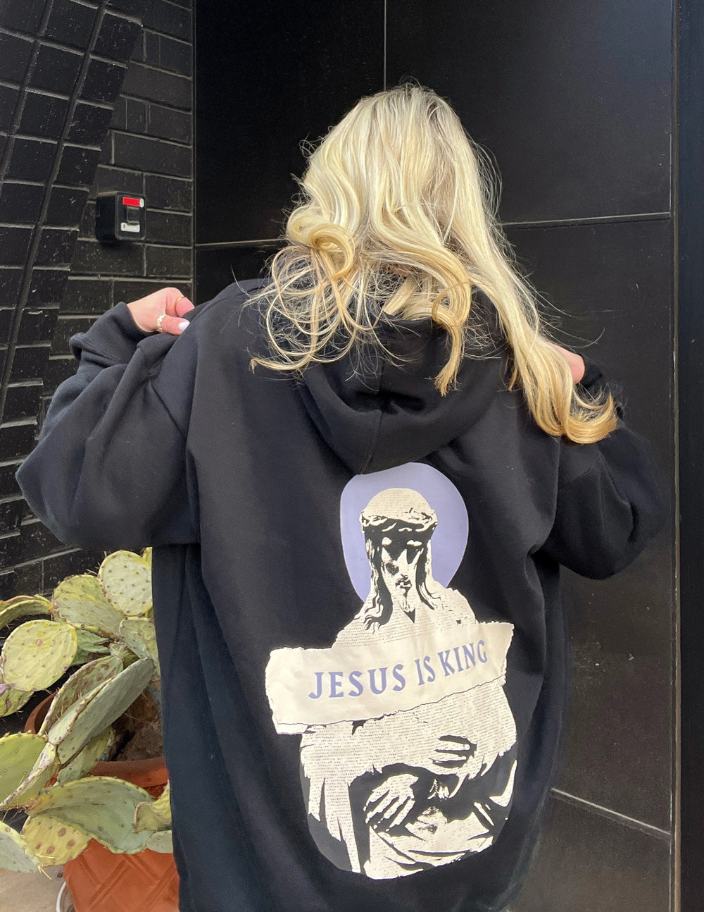 Black unisex hoodie with large back portrait graphic