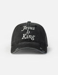 Black baseball cap with embroidered “Jesus Is King” on the front panel