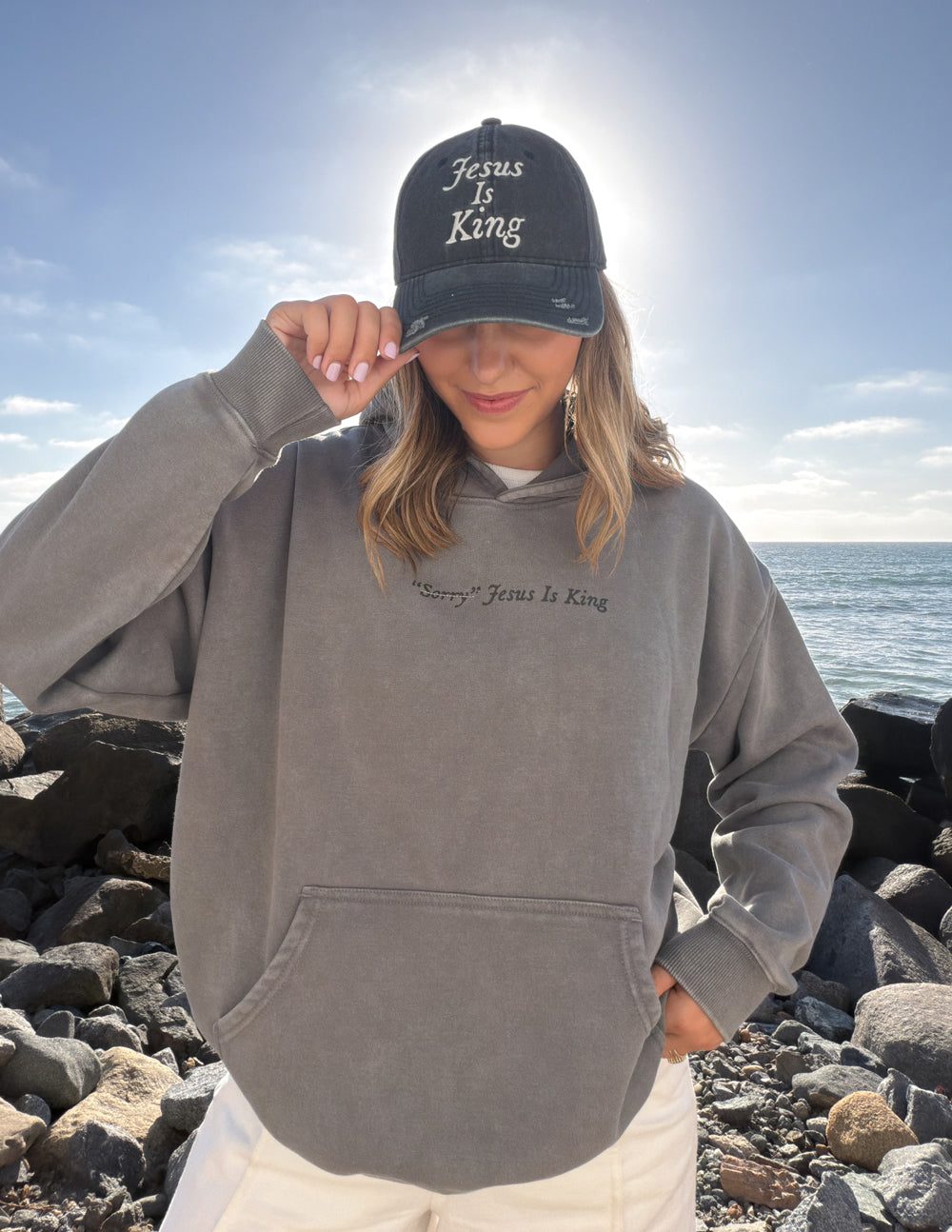 Black cap with “Jesus Is King” embroidered in script on the front