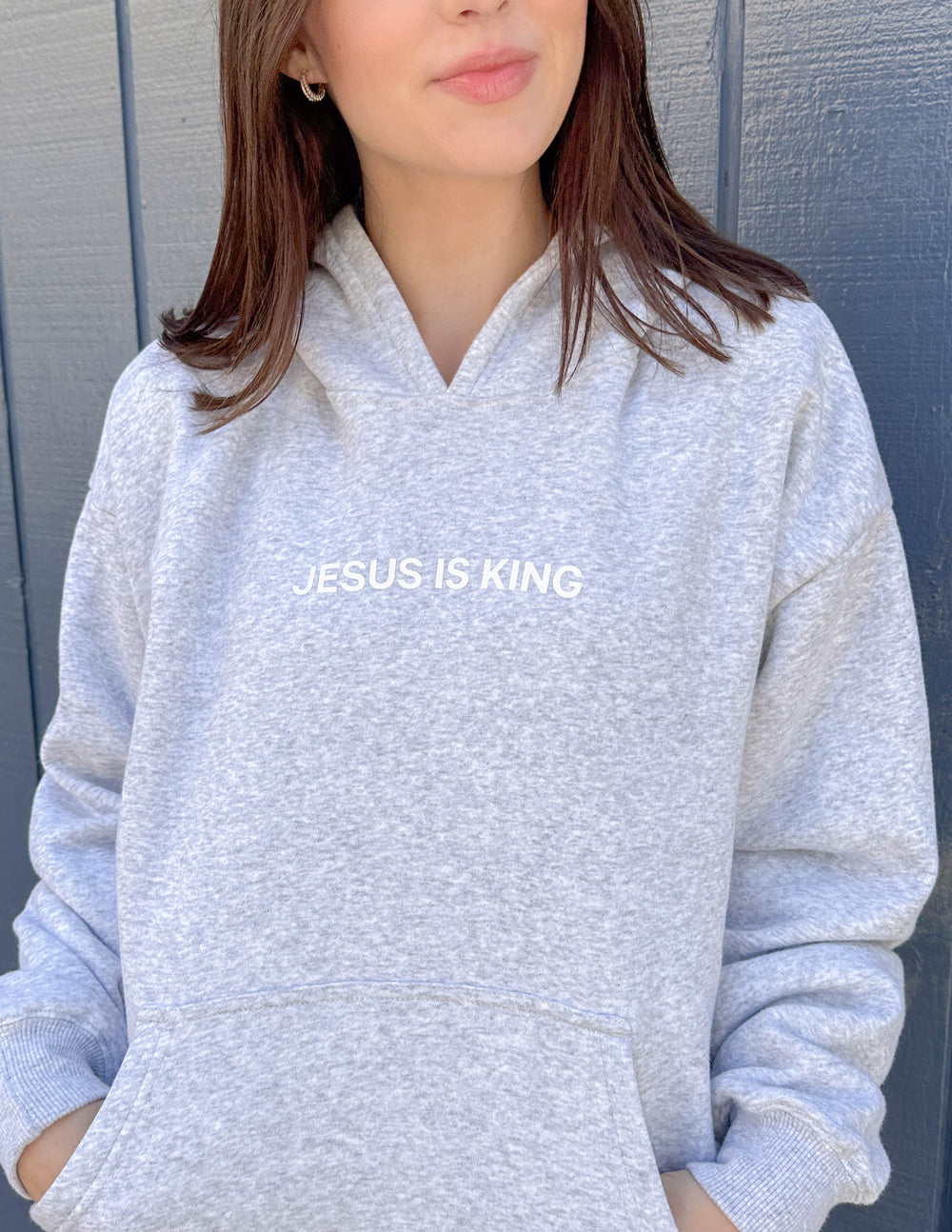 Heather grey unisex hoodie with hood and Jesus Is King chest print