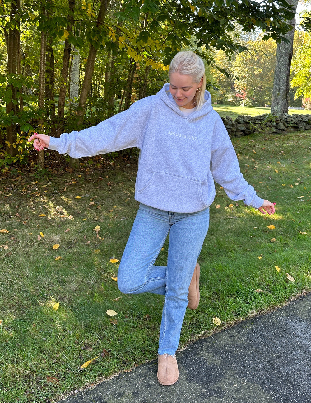 Heather grey unisex pullover hoodie with hood, long sleeves, and chest text