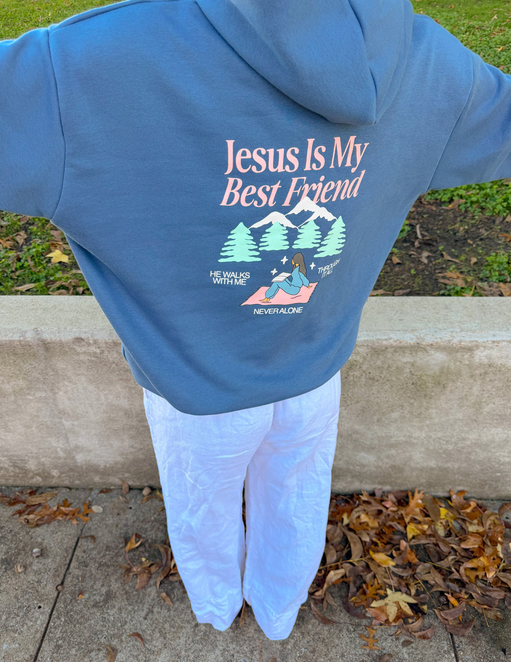 Blue unisex hoodie with back "Jesus Is My Best Friend" graphic and pine trees