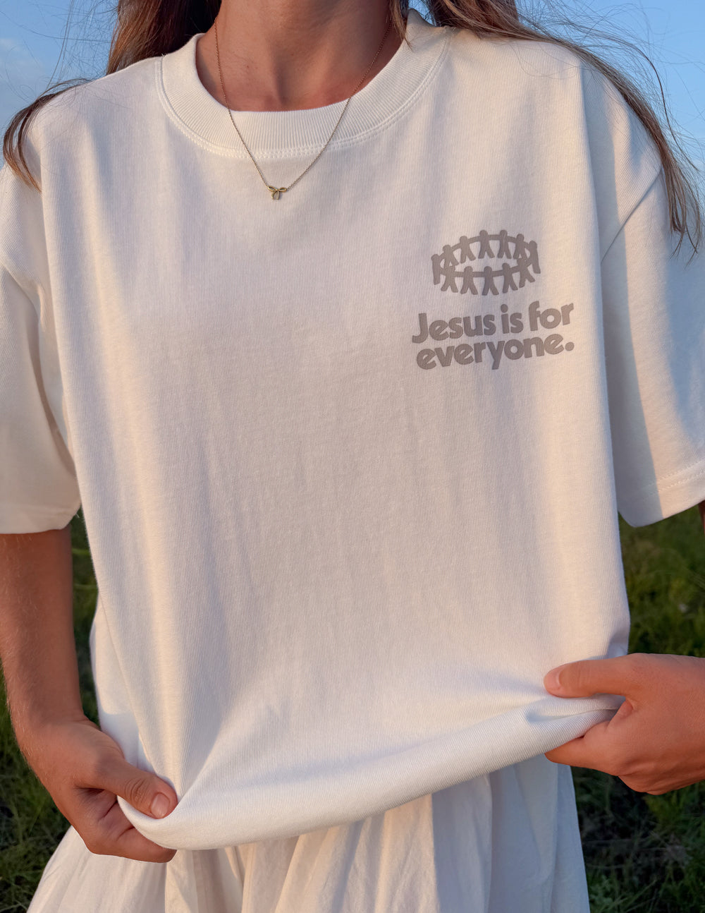 Close-up of white heavyweight T-shirt chest logo print and abstract figures