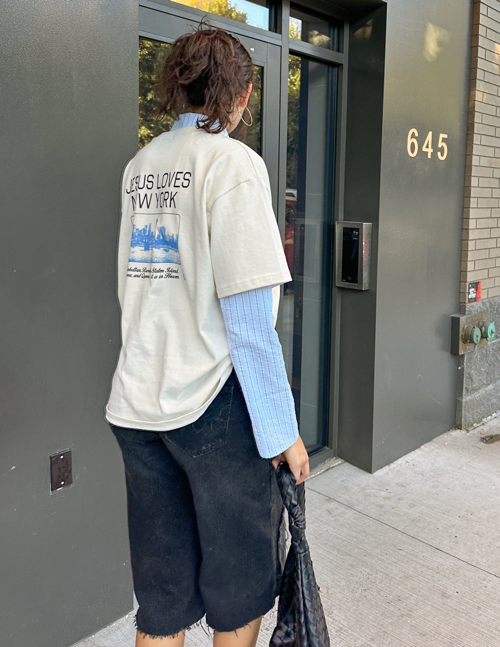 White heavyweight T-shirt showing back “JESUS LOVES NEW YORK” print