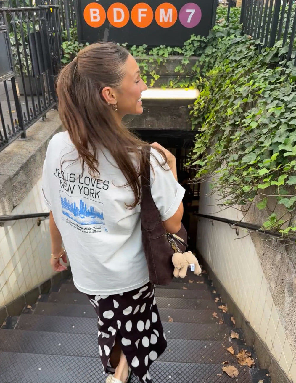 White heavyweight T-shirt with back “JESUS LOVES NEW YORK” skyline graphic