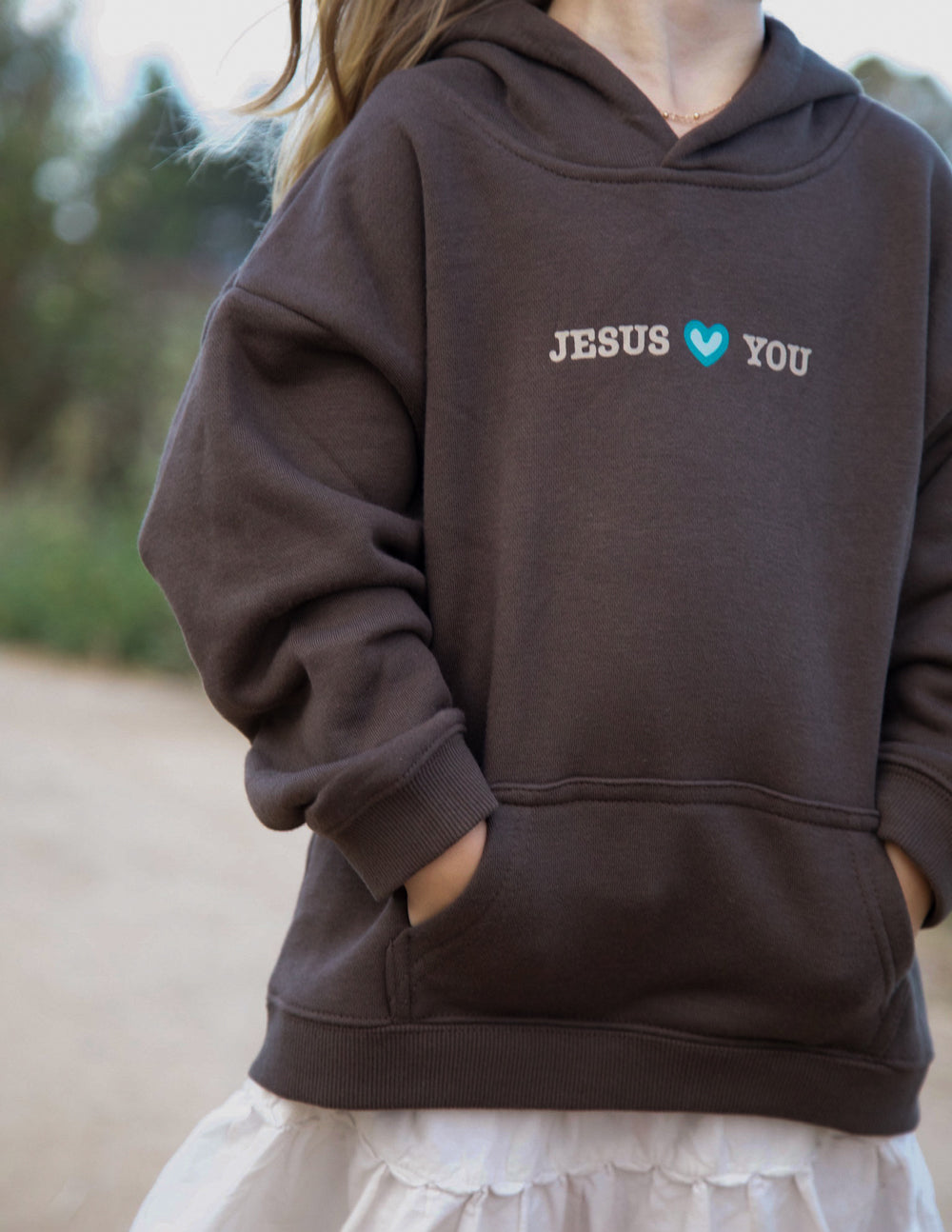 Kids pullover hoodie in dark brown with “JESUS” and heart icons on chest